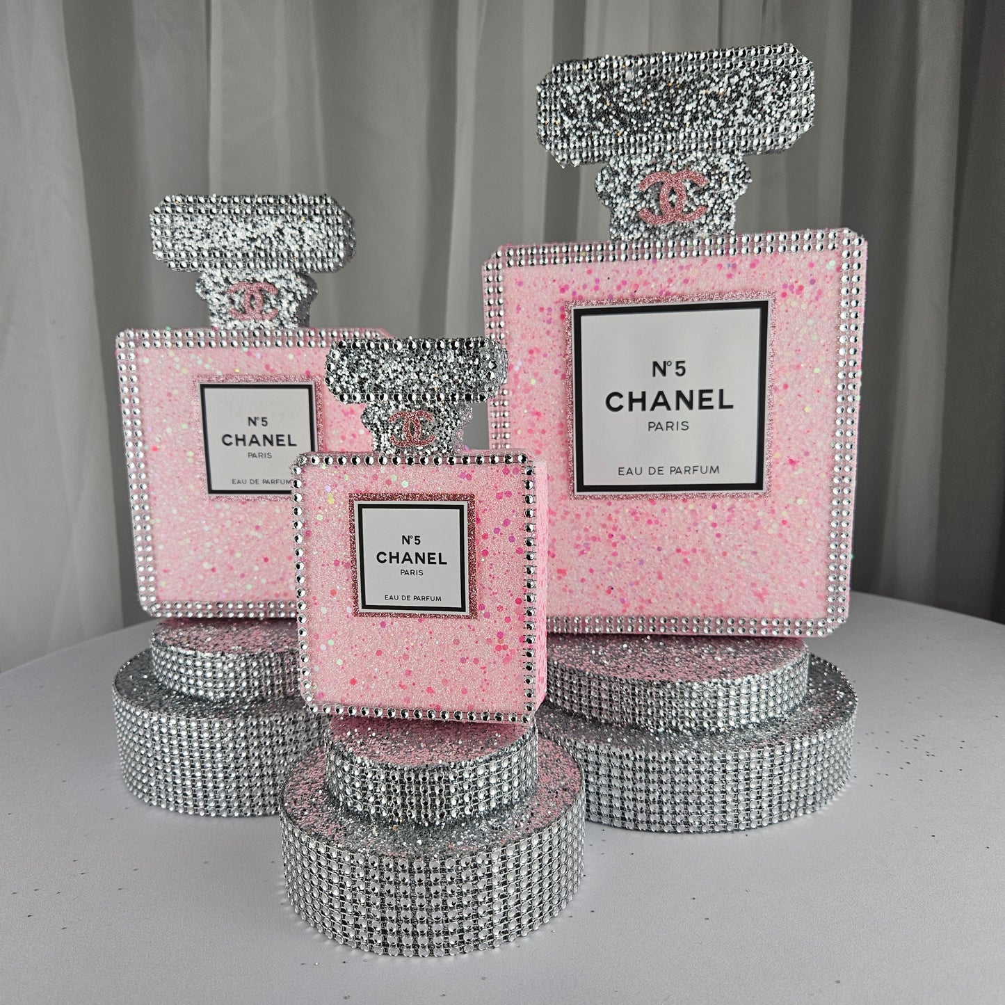 pink chanel birthday decorations Close up of base of Chanel inspired pink and silver perfume centerpiece