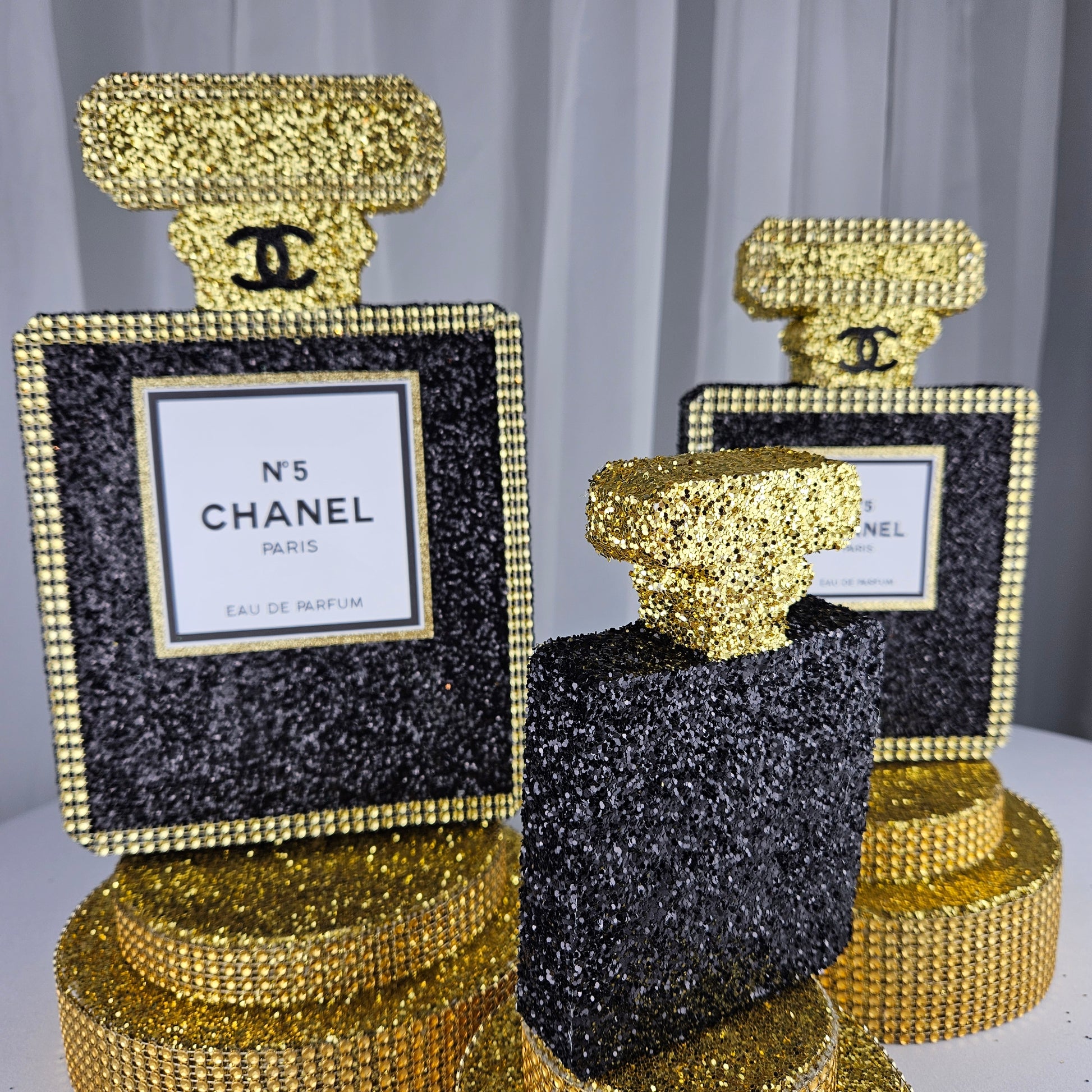 black and gold chanel birthday decorations Black Gold Chanel-inspired perfume bottle centerpiece for luxury glam birthday decor