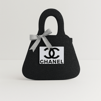 Black Chanel birthday centerpiece purse with silver bow, chic table décor for Chanel party decorations.