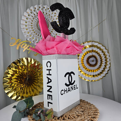 Close up of decorated Chanel inspired gift box centerpiece for luxury party decor