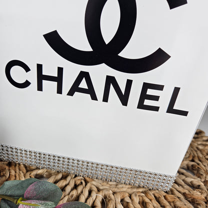 Tall Chanel inspired gift box centerpiece creating statement decor for glam birthday party