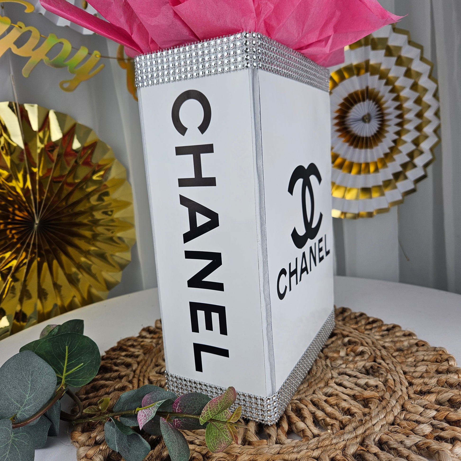 Lifestyle setup of Chanel inspired gift box centerpiece for glam and spa birthday party