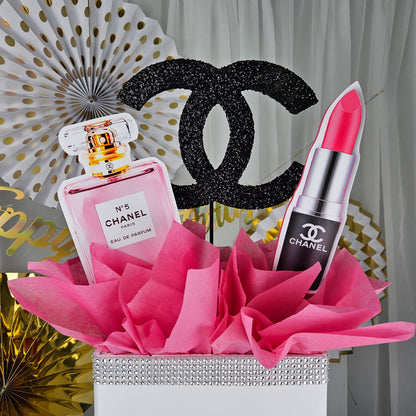 Chanel inspired gift box centerpiece styled on table for Paris themed birthday party