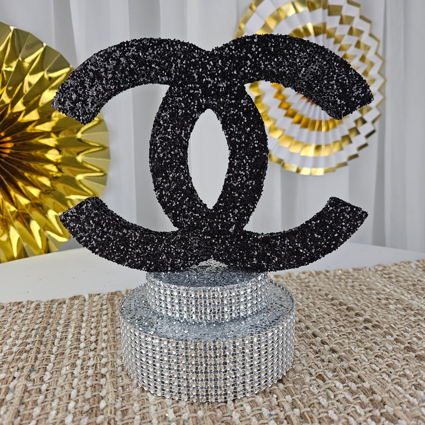 Chanel-inspired birthday centerpiece with silver glam base for luxury parties