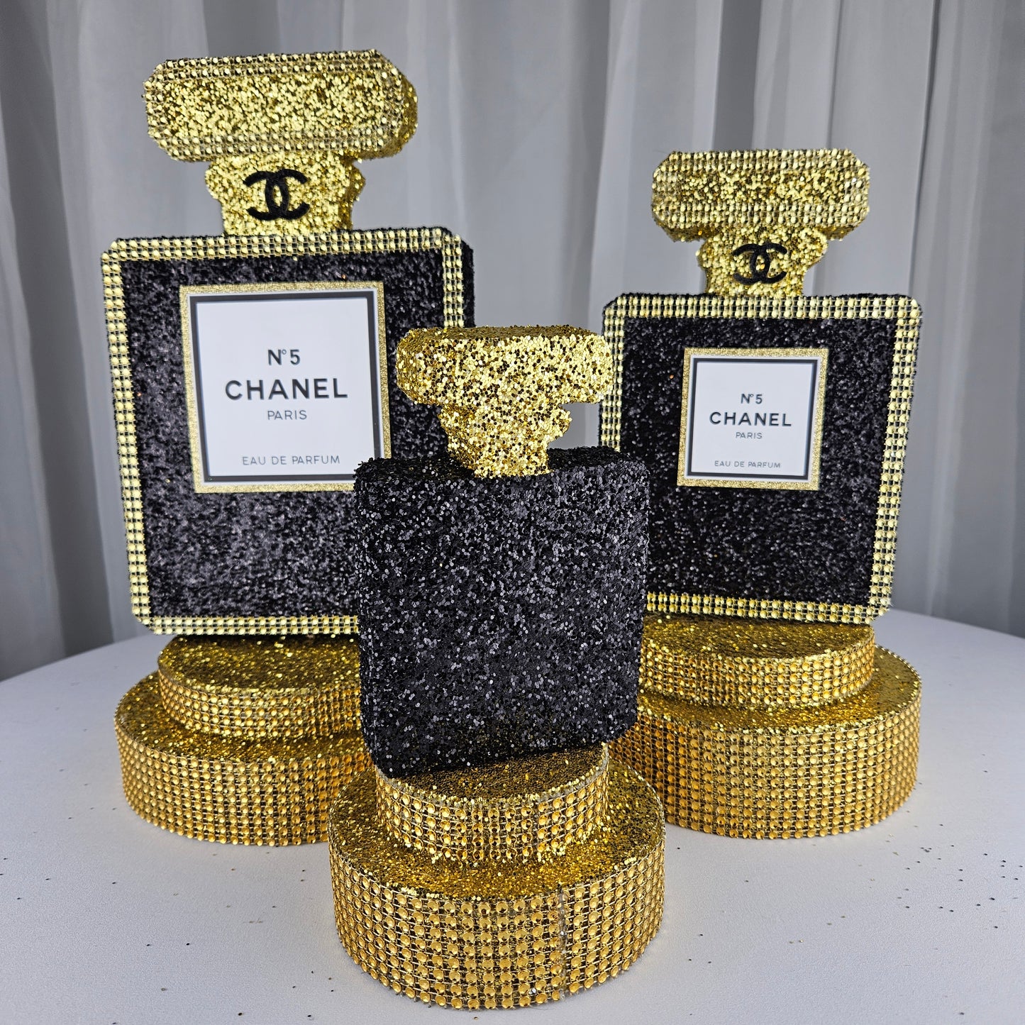 black and gold chanel birthday decorations Glam Chanel party perfume centerpiece with black glitter and gold accents