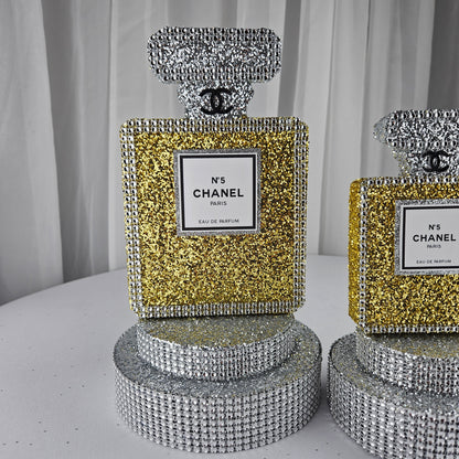 gold chanel birthday decorations Close up of luxurious gold and silver Chanel inspired party centerpiece for Paris theme birthday decorations