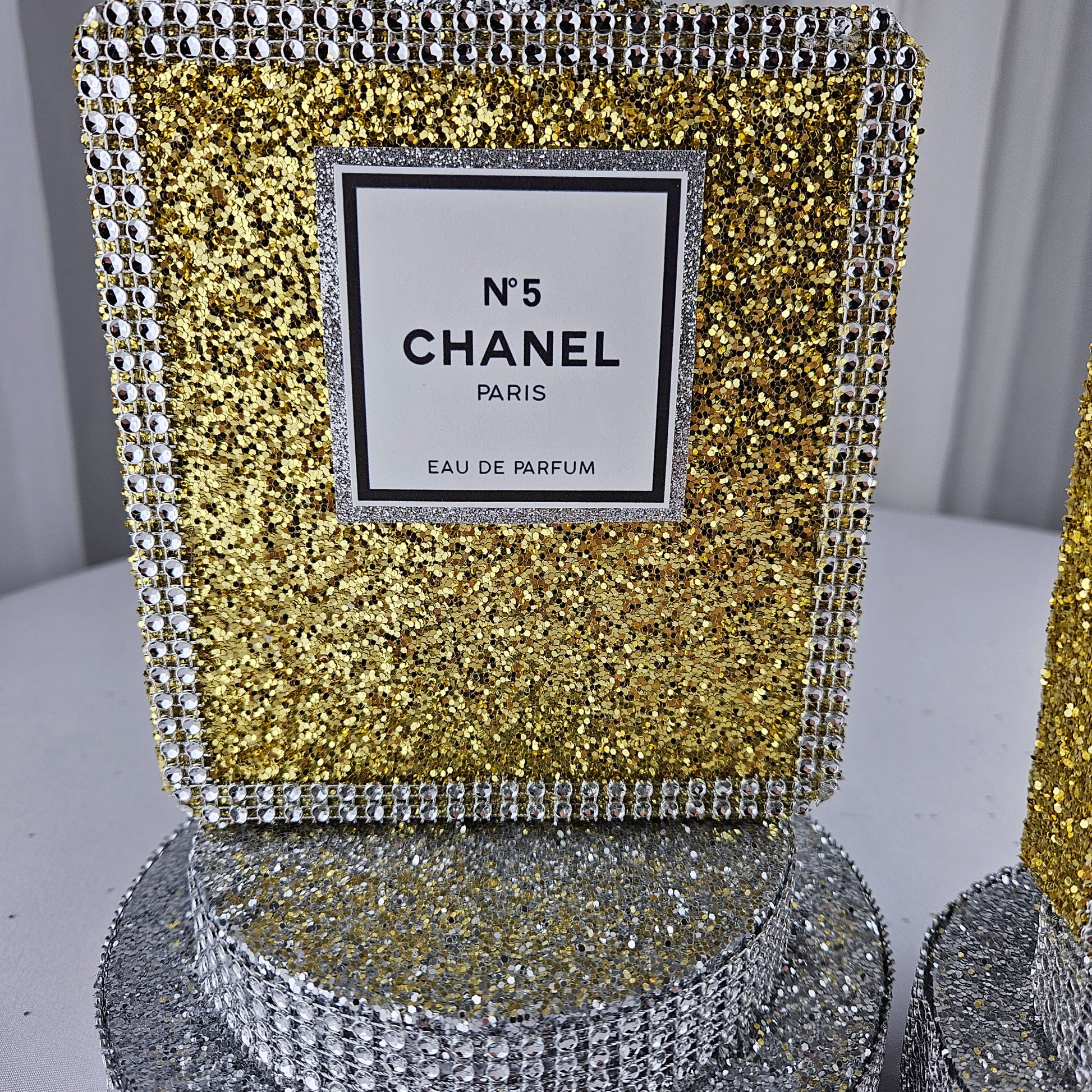 gold chanel birthday decorations Rhinestone accent on Chanel inspired perfume bottle centerpiece gold silver for luxury birthday decorations