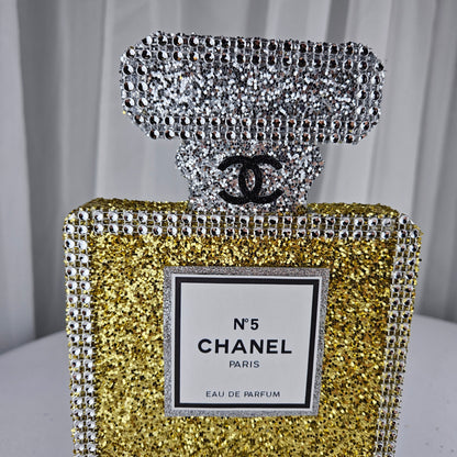 gold chanel birthday decorations Gold and silver Chanel perfume bottle party centerpiece styled on table for Paris themed birthday party