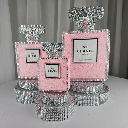 pink chanel birthday decorations Close up of base of Chanel inspired pink and silver perfume centerpiece
