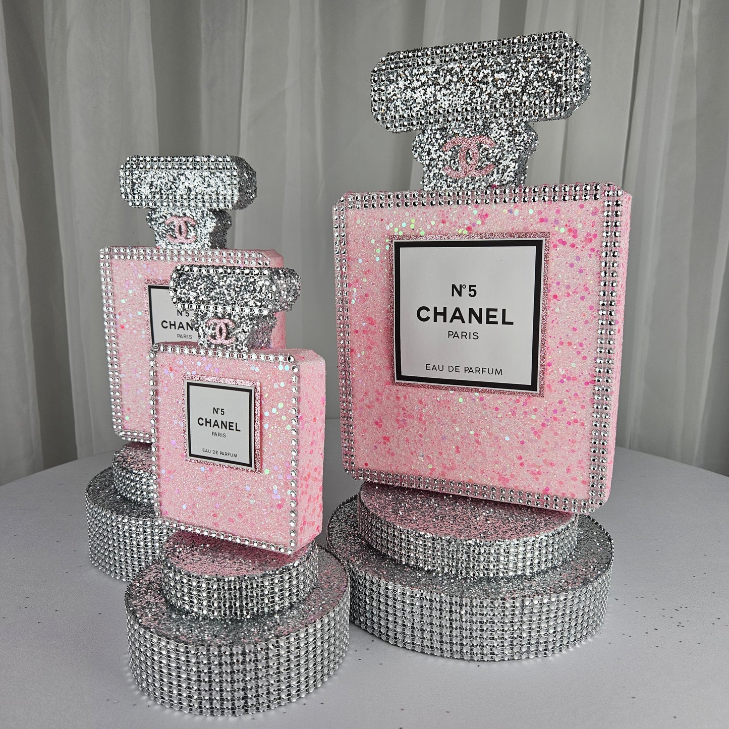 pink chanel birthday decorations Close up of Chanel inspired perfume label on pink and silver glam birthday centerpiece