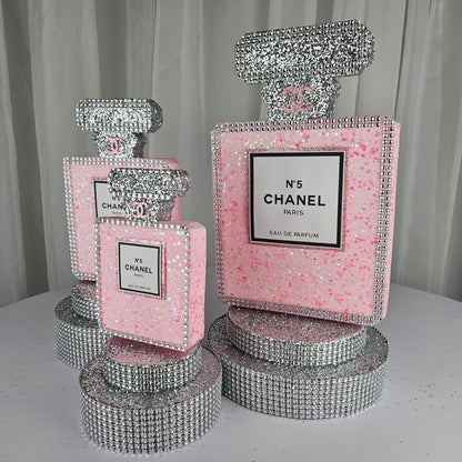 pink chanel birthday decorations Close up of Chanel inspired perfume label on pink and silver glam birthday centerpiece