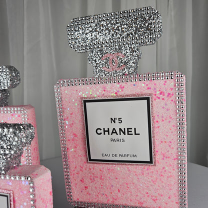 pink chanel birthday decorations Top detail of pink and silver Chanel inspired perfume centerpiece for luxury decor