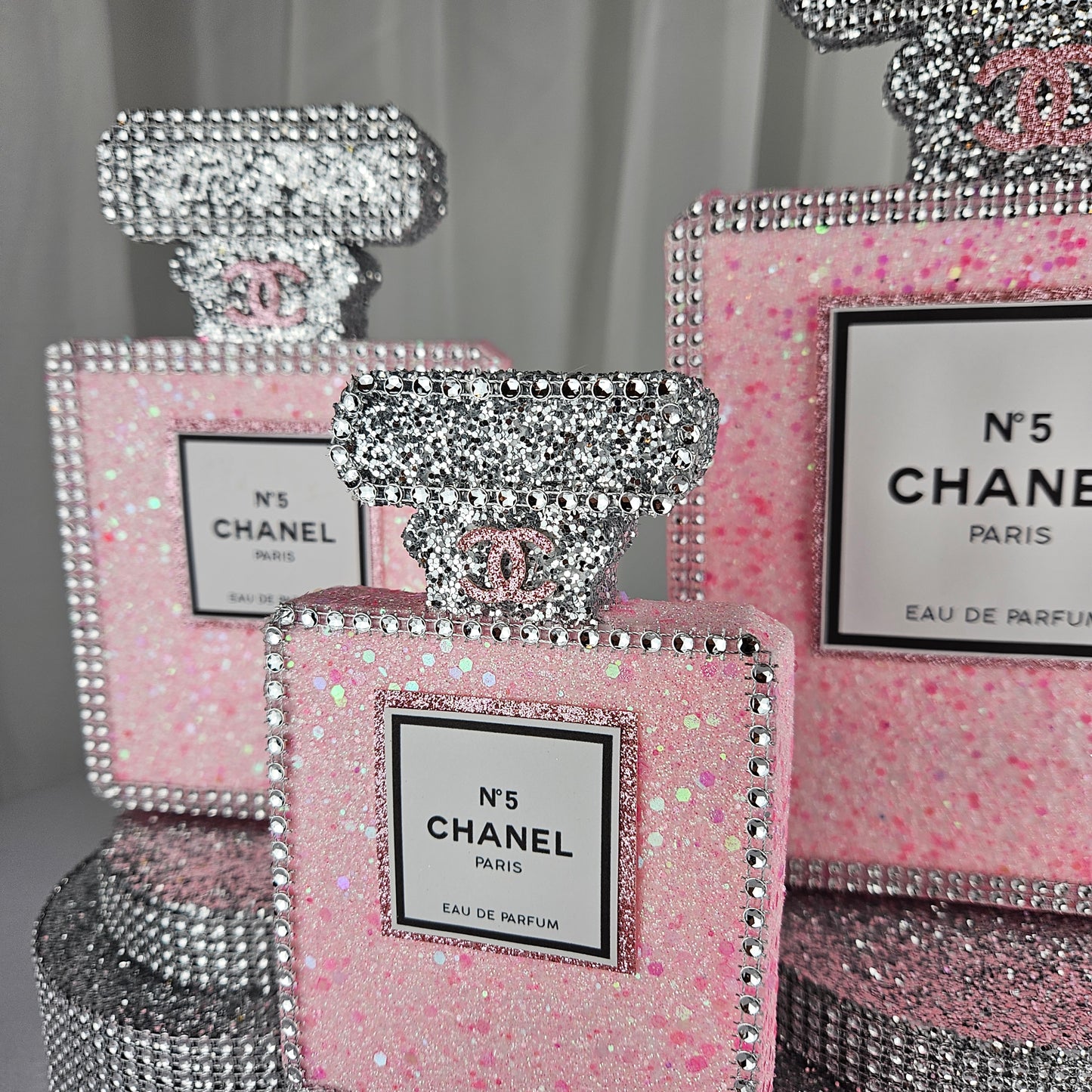 pink chanel birthday decorations Glitter detail on pink and silver Chanel inspired centerpiece for luxury birthday party