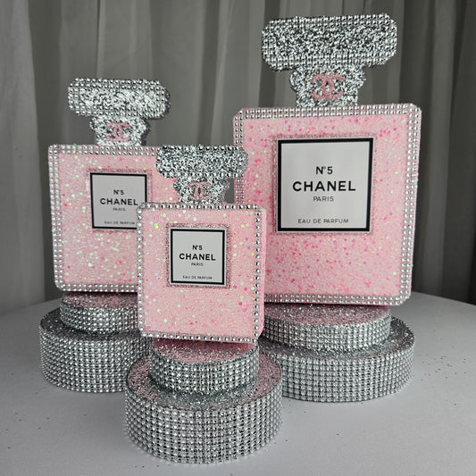 Chanel inspired perfume centerpiece in pink and silver for glam Paris themed birthday party decor

