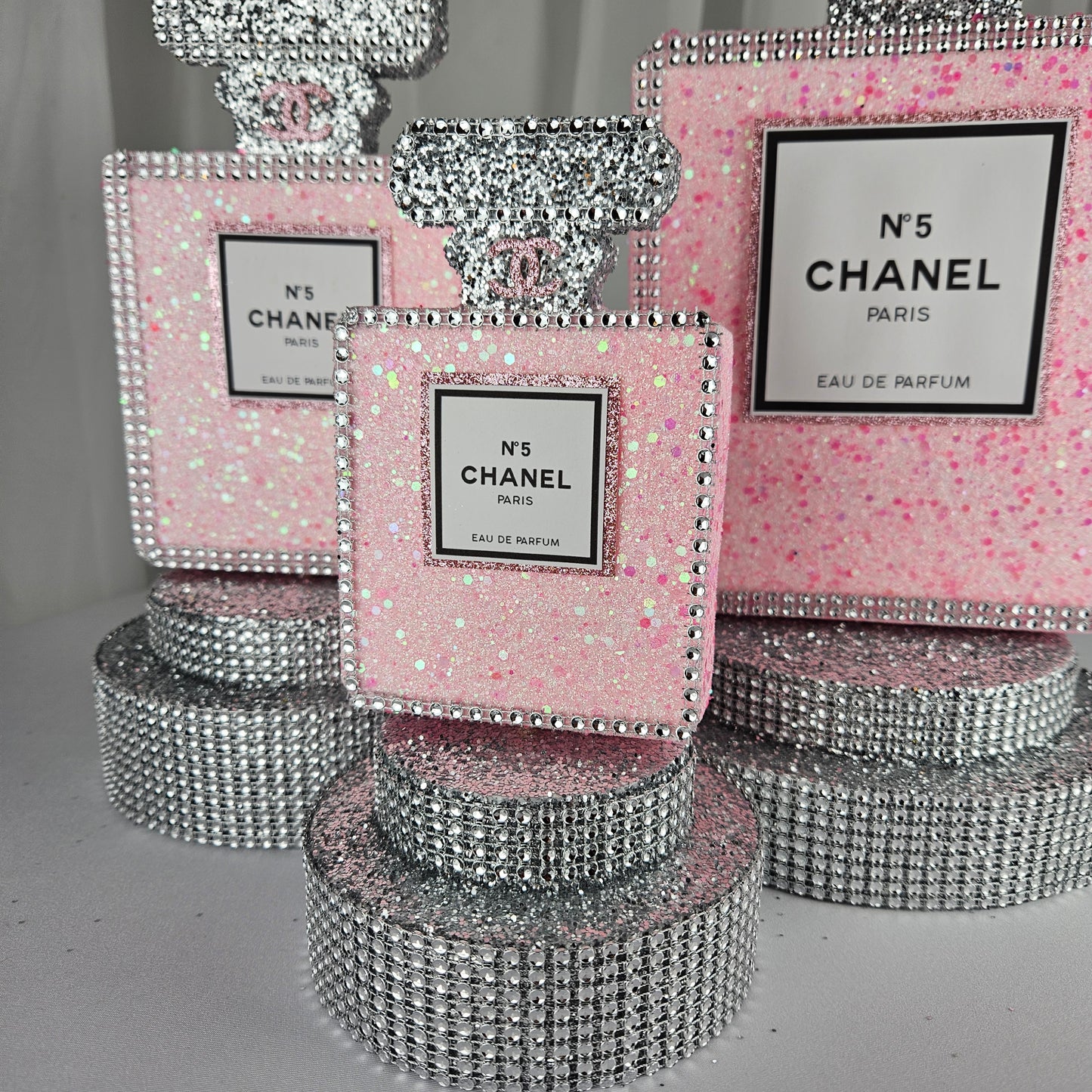 pink chanel birthday decorations Rhinestone trim detail on Chanel inspired perfume centerpiece pink and silver