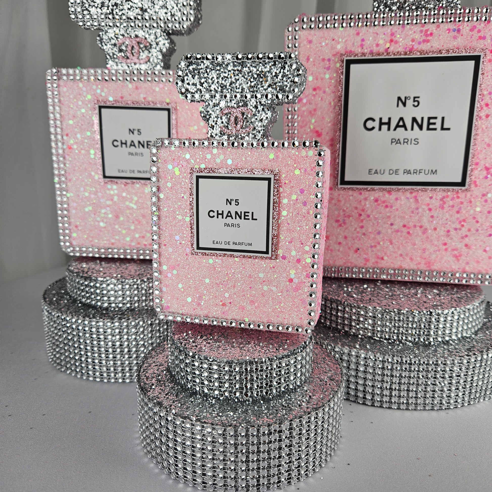pink chanel birthday decorations Rhinestone trim detail on Chanel inspired perfume centerpiece pink and silver