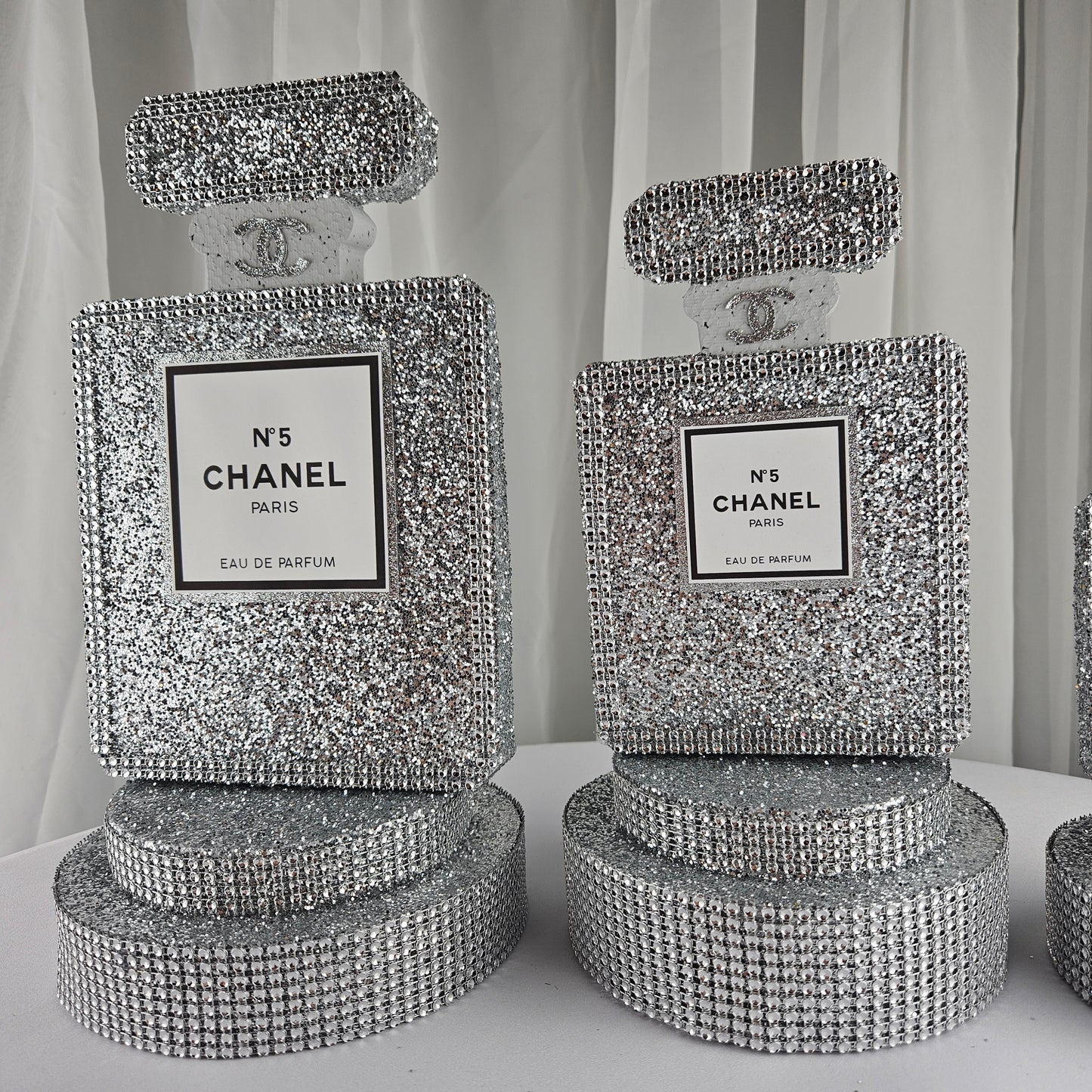 Close up of Chanel inspired label on silver glam birthday centerpiece