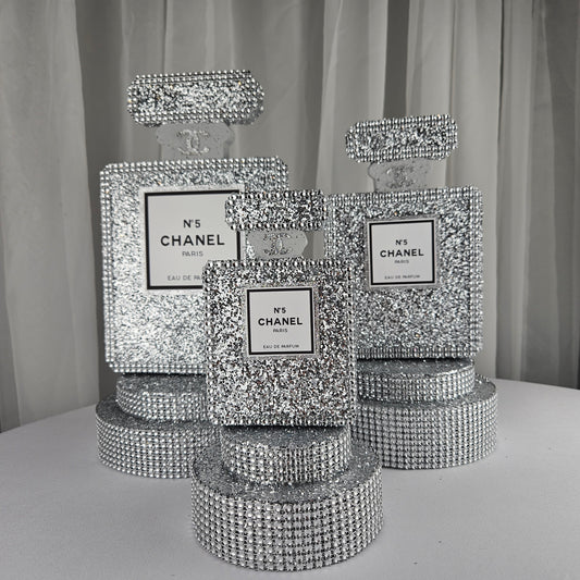 Front view of silver Chanel inspired perfume centerpiece for luxury birthday decorations