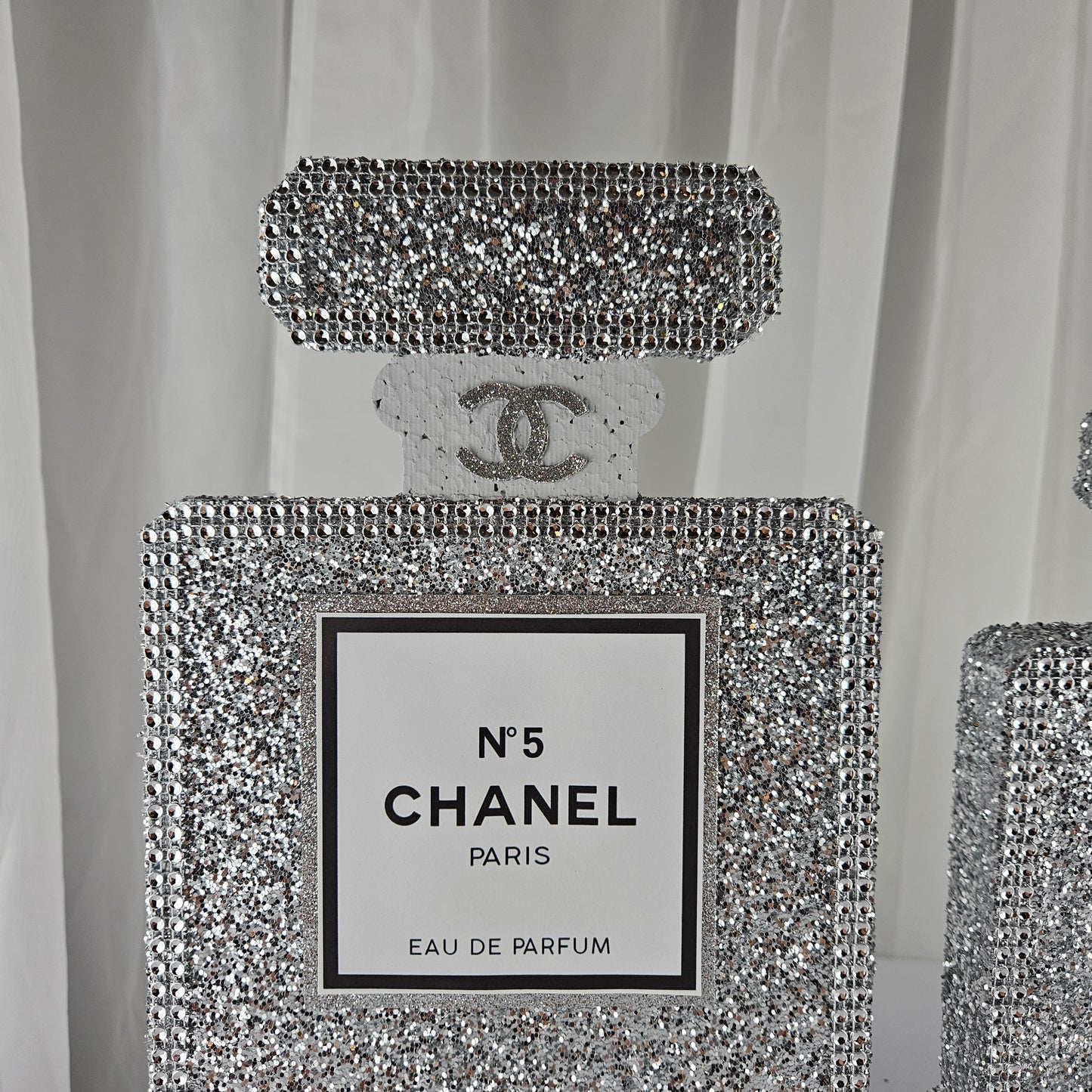 Set of silver Chanel inspired perfume centerpieces for Paris themed birthday decor