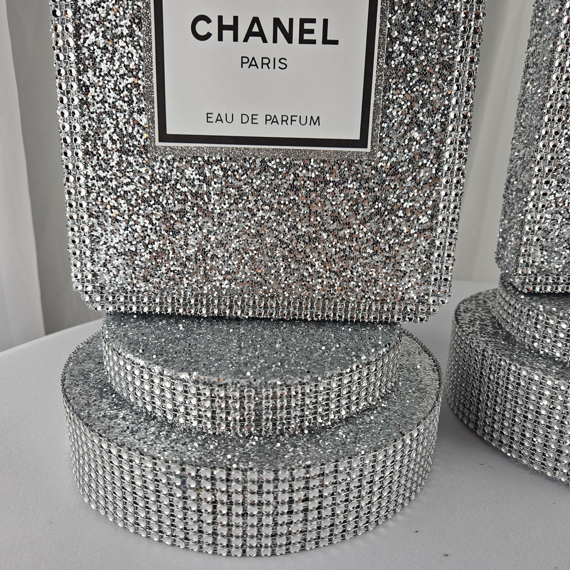 Size view of Chanel inspired silver perfume centerpiece for party table
