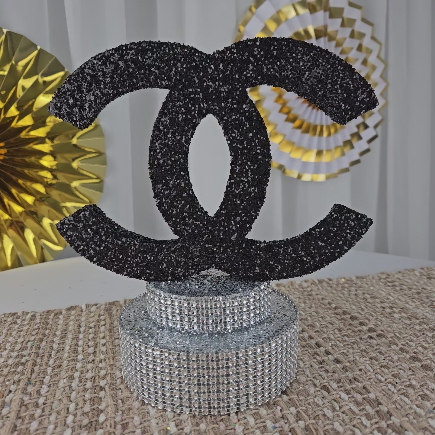 Luxury Chanel party centerpiece with black glitter and silver base