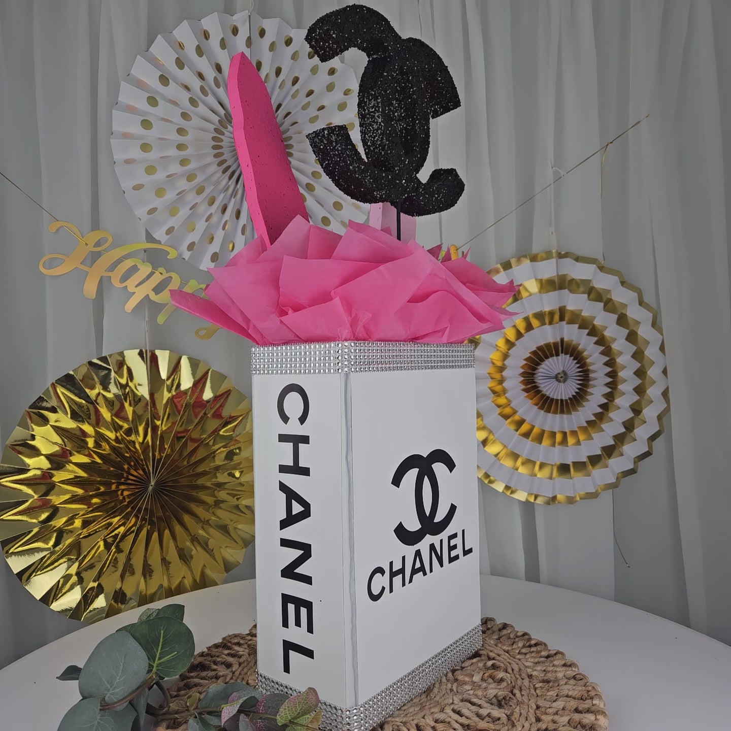 Chanel inspired gift box centerpiece with tissue paper and fashion toppers for Paris themed party
