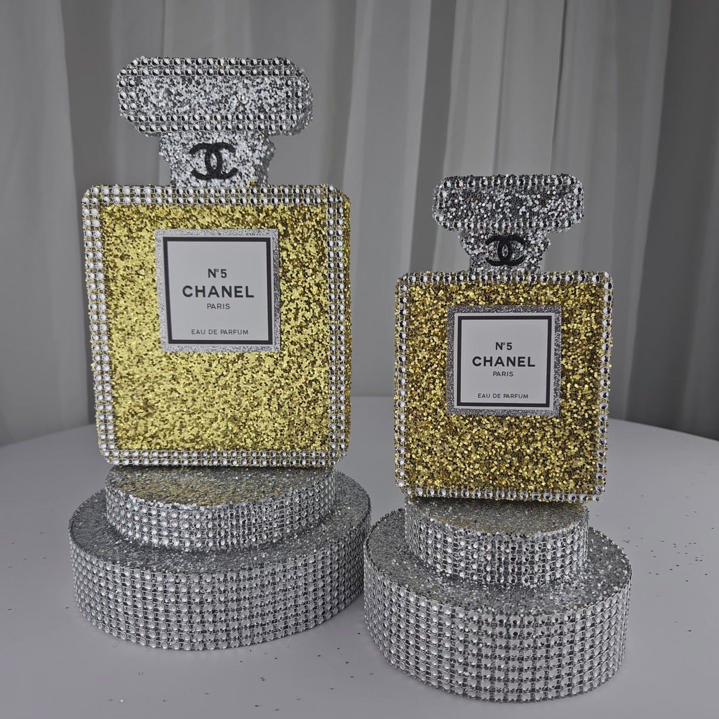 Handmade Chanel perfume bottle centerpiece in gold and silver for glam Paris birthday party decorations