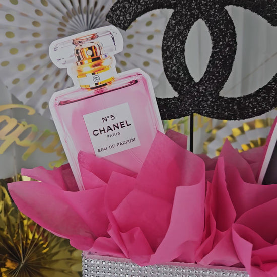 Front view of Chanel inspired gift box centerpiece with luxury party decor style