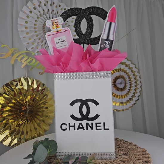 Angled view of Chanel inspired gift box centerpiece for glam birthday decorations